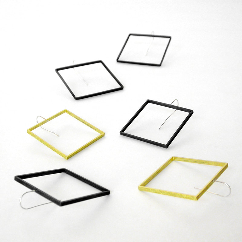 square slice earrings in black and yellow brass