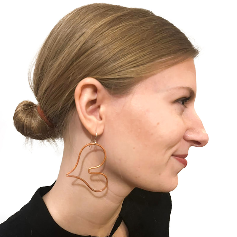 Simple Hearts Earrings in witty orange copper on model by Emanuela Aureli