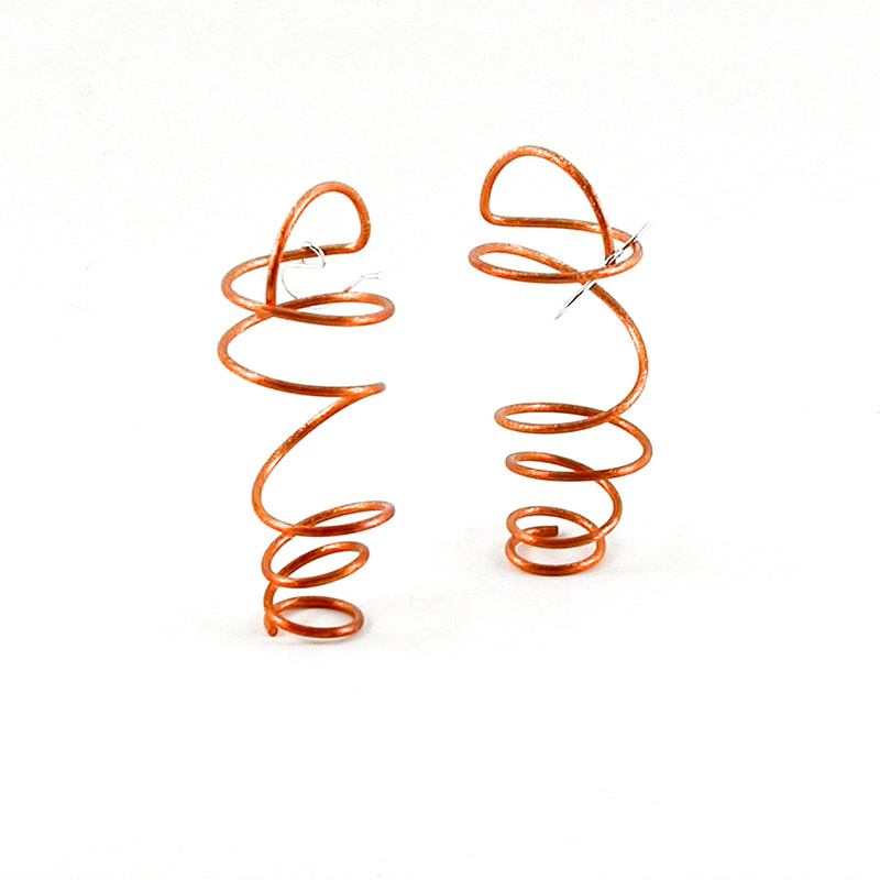 Swinging Coil Earrings in the witty orange copper finish