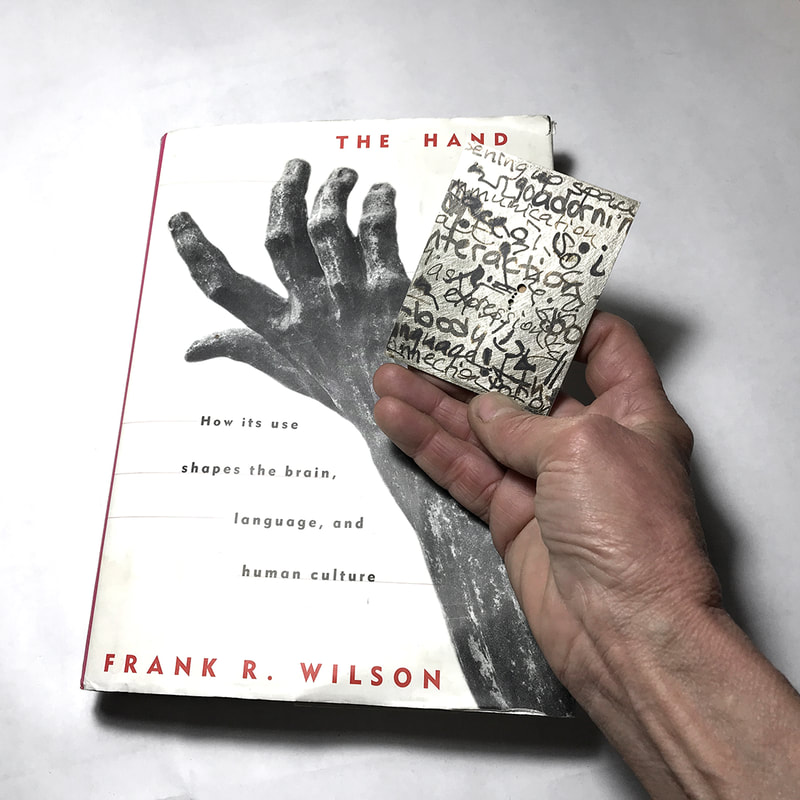 Book+hand holding Water Pin